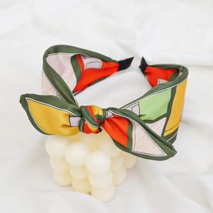 Detail shot of a geometric pattern knot headband on a white decorative stand