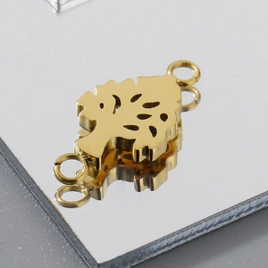 Macro shot of gold tree of life connector with dual rings for DIY jewelry making