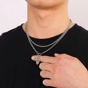 Close-up of double-layer stainless steel Cuban chain necklace with skull pendant on model