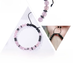 Detail of Morse code bracelet with pink and black beads on adjustable cord and message card