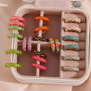 Detailed grid showing colorful enamel checkerboard pattern on C-shaped stud earrings