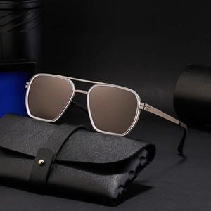 Polarized aviator sunglasses with silver metal frame and brown lenses on leather case