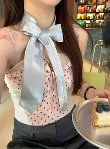 Elegant light blue satin bow choker necklace shown in a sweet lifestyle setting