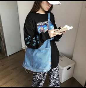 Detail of soft washed denim tote bag with spacious interior and wide shoulder straps