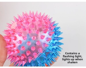 Close-up of dual-color glowing spike ball toy with vibration sensor light and soft texture