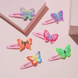Detailed view of six colorful PVC butterfly hair clips with metal BB bases for children