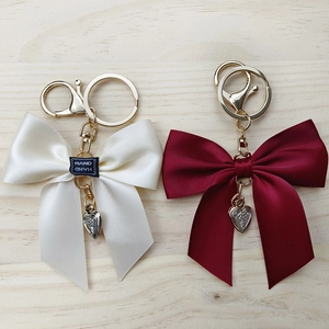 Fashionable silk ribbon bow keychain with heart pendant in beige and burgundy colors