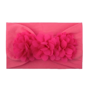 Detail of soft pink chiffon flowers on flexible nylon baby girl headband for toddlers