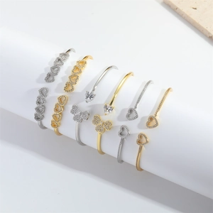 Minimalist open bangle with heart and clover designs featuring sparkling zircon accents