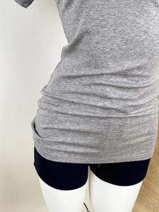 Detail of grey Tencel wool knit fabric showing premium texture and V-neckline stitching