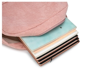 Pink corduroy backpack interior detail showing large capacity for multiple notebooks