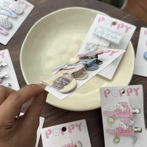 Detail of Westie dog hair clips with candy colors and smooth acrylic duckbill clamp
