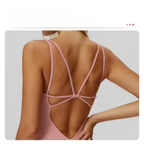Pink yoga bodysuit featuring cross back thin straps and hollow out back design details