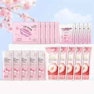 Detailed set of Sakura mud mask sachets and honey peach scrub on a white platform