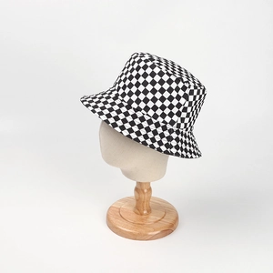 Detail of a black and white checkerboard bucket hat on a display mannequin stand