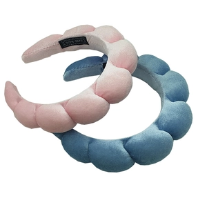 Close-up of pink and blue velvet padded headbands with handmade label texture details