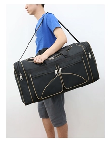 Detail of black oxford travel bag with gold trim, large capacity and detachable shoulder strap