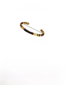 Detail view of 58mm bamboo-style enamel bangle in black and gold plated titanium steel