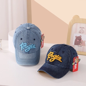 Close-up of denim baseball caps in dark and light blue with Rogie letter embroidery
