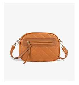 Detailed view of caramel brown quilted PU leather crossbody bag with golden hardware