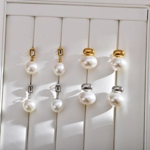 Retro pearl stud earrings set in gold and silver finish with rhinestone accents