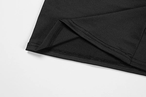 Detailed macro view of professional double-needle stitching on black knit dress fabric