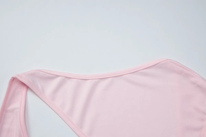 Close-up of pink slim fit tank top featuring irregular neckline and high-quality stitching