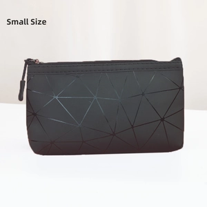 Detailed macro view of small black cosmetic bag with 3D geometric triangular patterns