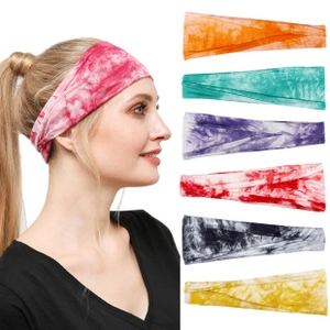 Close-up of tie-dye moisture-wicking headbands in multiple vibrant colors for yoga