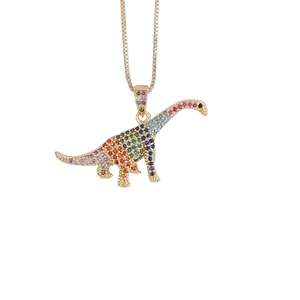 Macro shot of hip hop dinosaur pendant with colorful cubic zirconia on gold chain