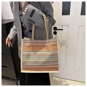 Detail of vintage ethnic geometric pattern on a large canvas tote bag with woven handles