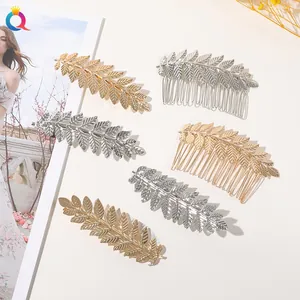 Detailed view of gold and silver metal leaf hair pins and clips with textured vein patterns