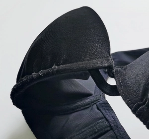 Close-up of black velvet bra stitching and strap connection for push-up support