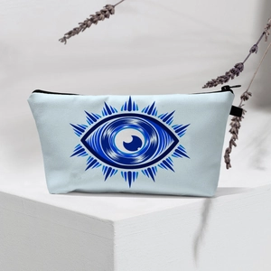 Detail of waterproof evil eye travel bag on pedestal with lavender and canvas texture