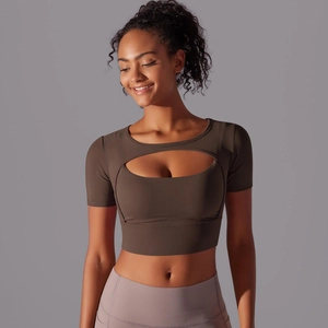 Detail of coffee brown yoga top featuring sheer mesh patchwork and layered bust design