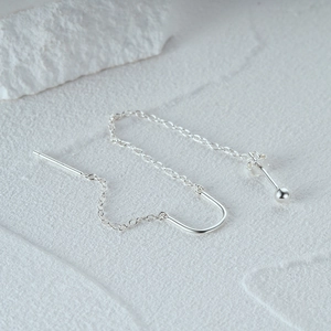Detailed macro of S925 sterling silver earring threads with U-shaped hook on stone