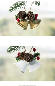 Detailed view of festive Christmas bells in gold and silver with pine cones and red berries
