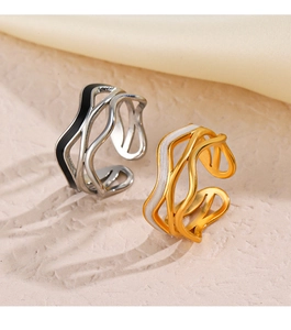 Macro view of wave-shaped open rings with colorful enamel details and metallic finish