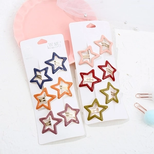 Detailed close-up of 12 matte star-shaped hair clips in various colors on display card