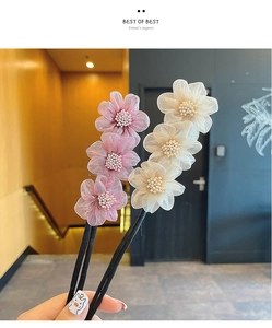 Detail of floral hair bun makers with sheer pink and cream petals and pearl centers