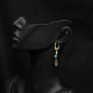 Bohemian gold hoop long earrings with green stones and pearl on black profile model