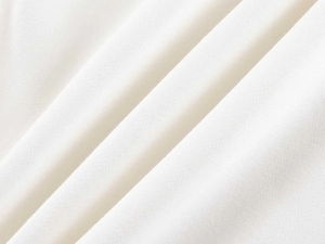 Macro shot of white knitted fabric texture showing premium cotton material details