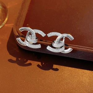 Detailed view of silver double C earrings with zircon inlays and elegant shadow casting