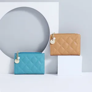 Short minimalist quilted leather wallet with pearl zipper pendant in blue and camel colors