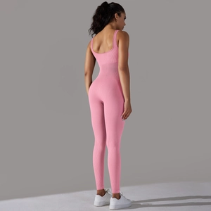 Detail view of the pink ribbed seamless jumpsuit with an open back U-cut design