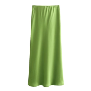 Détail de la jupe midi en satin vert brillant montrant le tissu fluide sur fond blanc