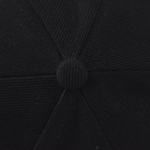 Macro shot of the black baseball cap crown showing six-panel stitch and top button
