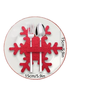Set of red snowflake cutlery holders made of felt for Christmas holiday table decorations