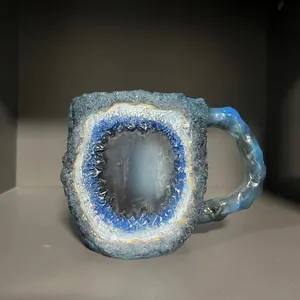 Blue mineral geode style coffee mug with raw stone texture and elegant gold rim design