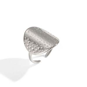 Macro detail of silver open ring with unique textured surface and metallic luster